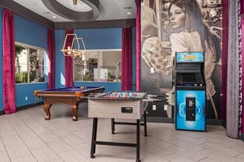 Resident clubhouse featuring billiards, retro arcade games, a photobooth, and stylish entertaining space